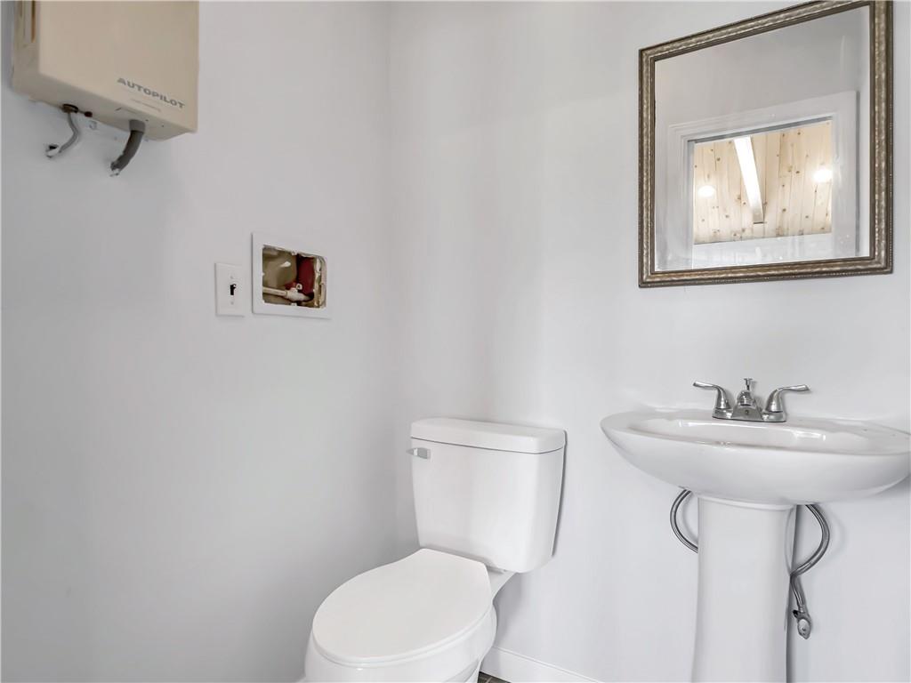 335 Canvasback Trail Locust Grove, GA 30248 - Photo 7 of 91 a bathroom with a toilet sink and mirror