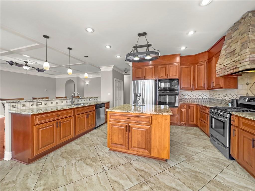 335 Canvasback Trail Locust Grove, GA 30248 - Photo 72 of 91 a large kitchen with stainless steel appliances granite countertop a stove a sink dishwasher and a refrigerator