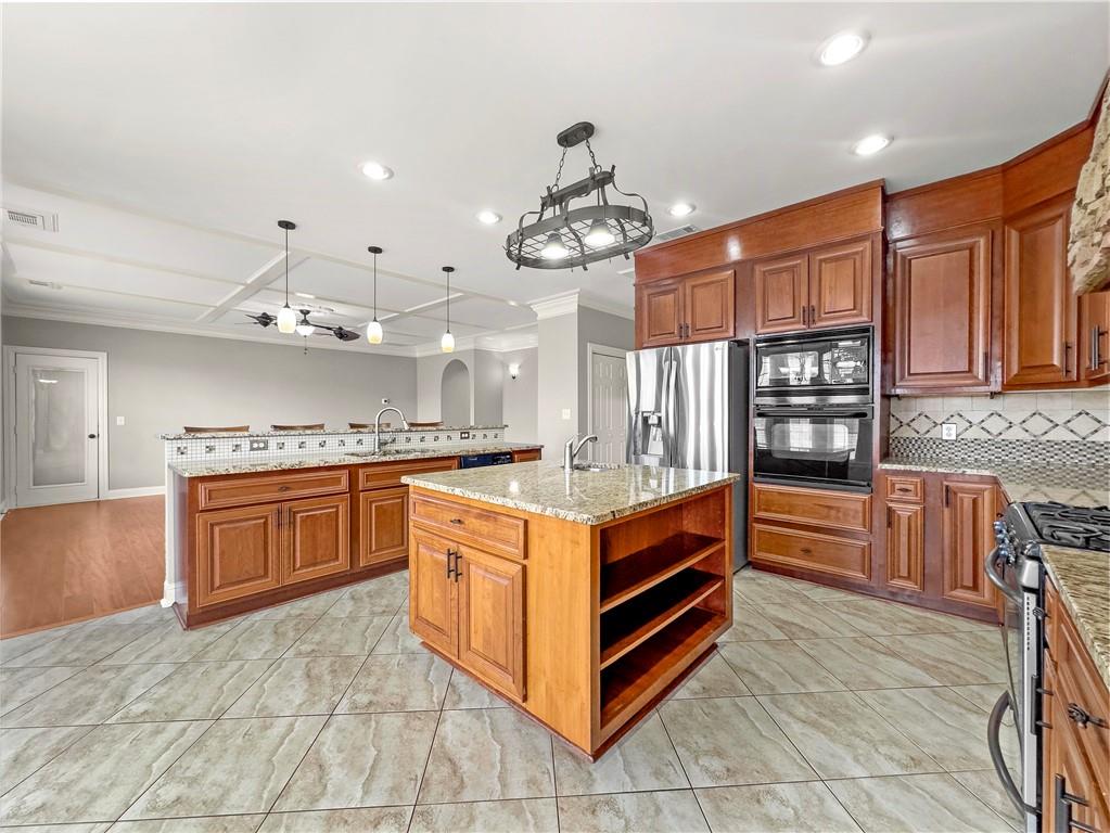 335 Canvasback Trail Locust Grove, GA 30248 - Photo 73 of 91 a kitchen with stainless steel appliances granite countertop a stove oven and a refrigerator