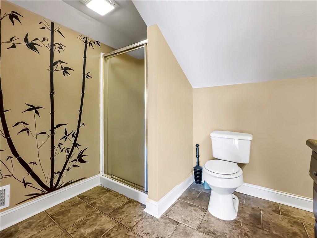 335 Canvasback Trail Locust Grove, GA 30248 - Photo 8 of 91 a bathroom with a toilet sink and shower