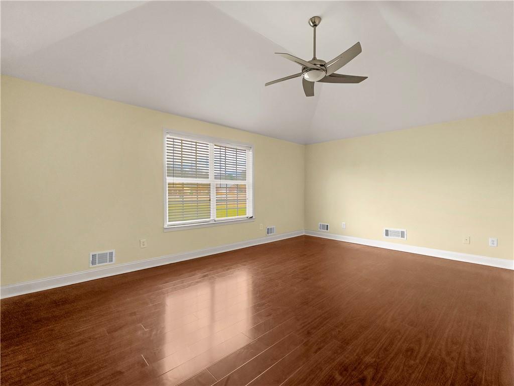 335 Canvasback Trail Locust Grove, GA 30248 - Photo 86 of 91 an empty room with wooden floor fan and windows