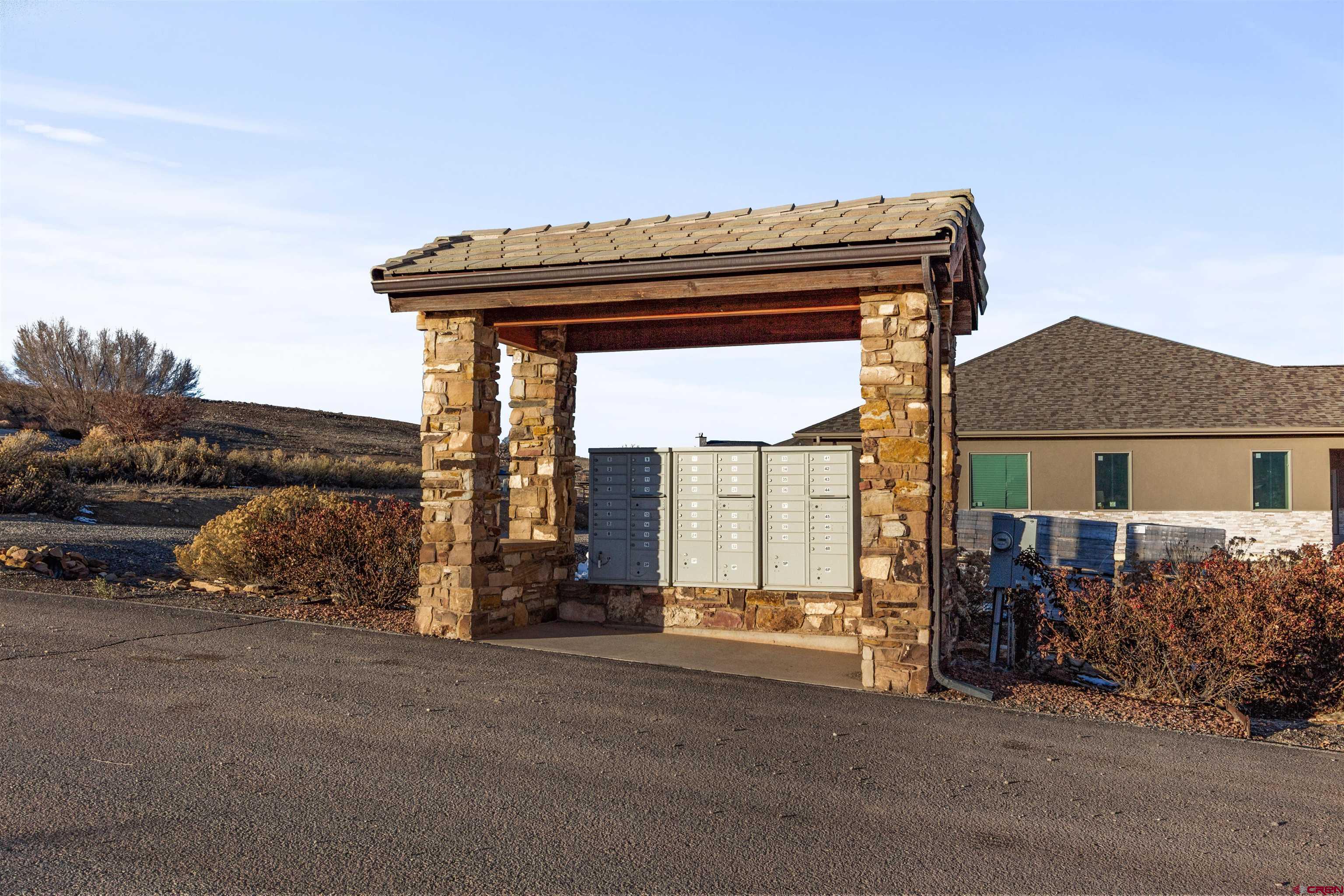 Lot 9 Lone Eagle Road Montrose, CO 81403 - Photo 21 of 21 a roof deck with table and chairs next to a yard