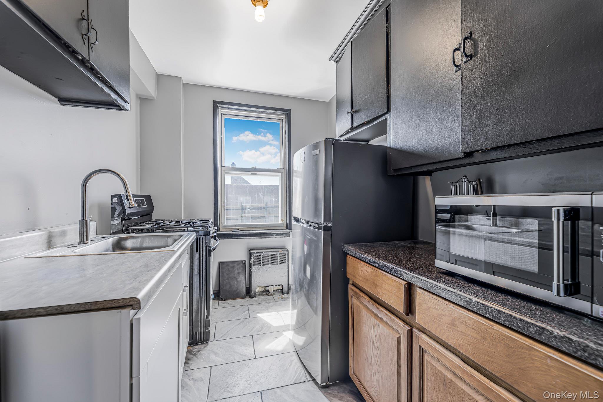 150 Ravine Avenue, Unit 3B Yonkers, NY 10701 - Photo 5 of 9 a kitchen with stainless steel appliances granite countertop a sink stove and refrigerator