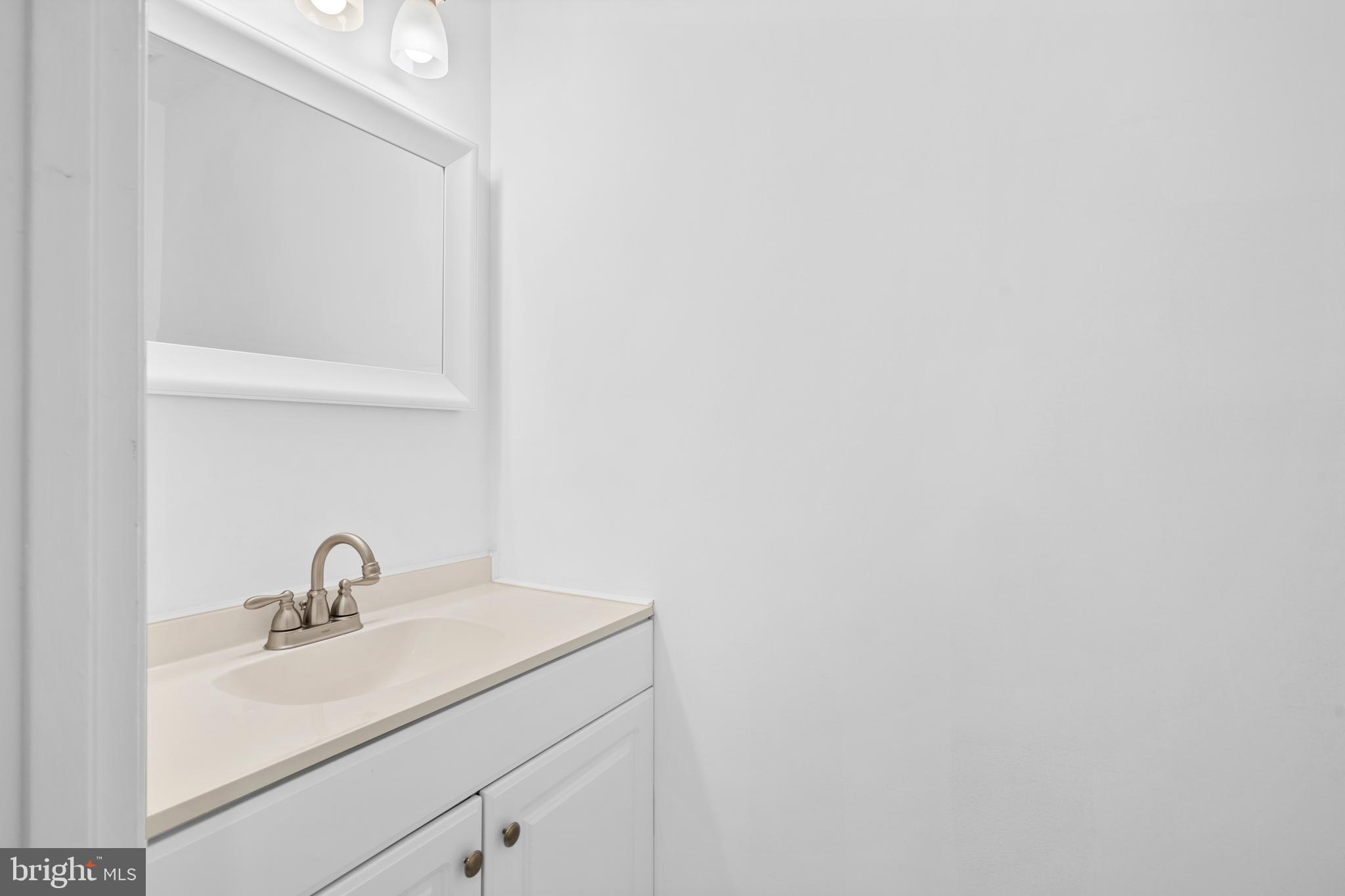 1007 Stoneham Drive, Unit 1007B Newtown Square, PA 19073 - Photo 11 of 31 a bathroom with a sink and mirror