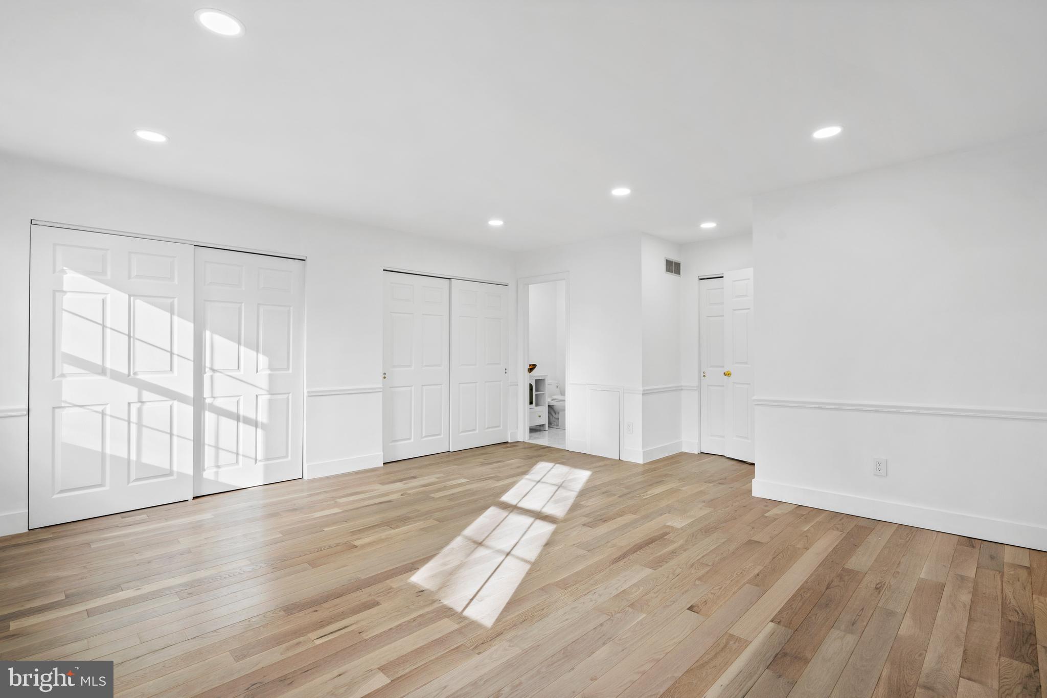 1007 Stoneham Drive, Unit 1007B Newtown Square, PA 19073 - Photo 12 of 31 a view of an empty room with wooden floor