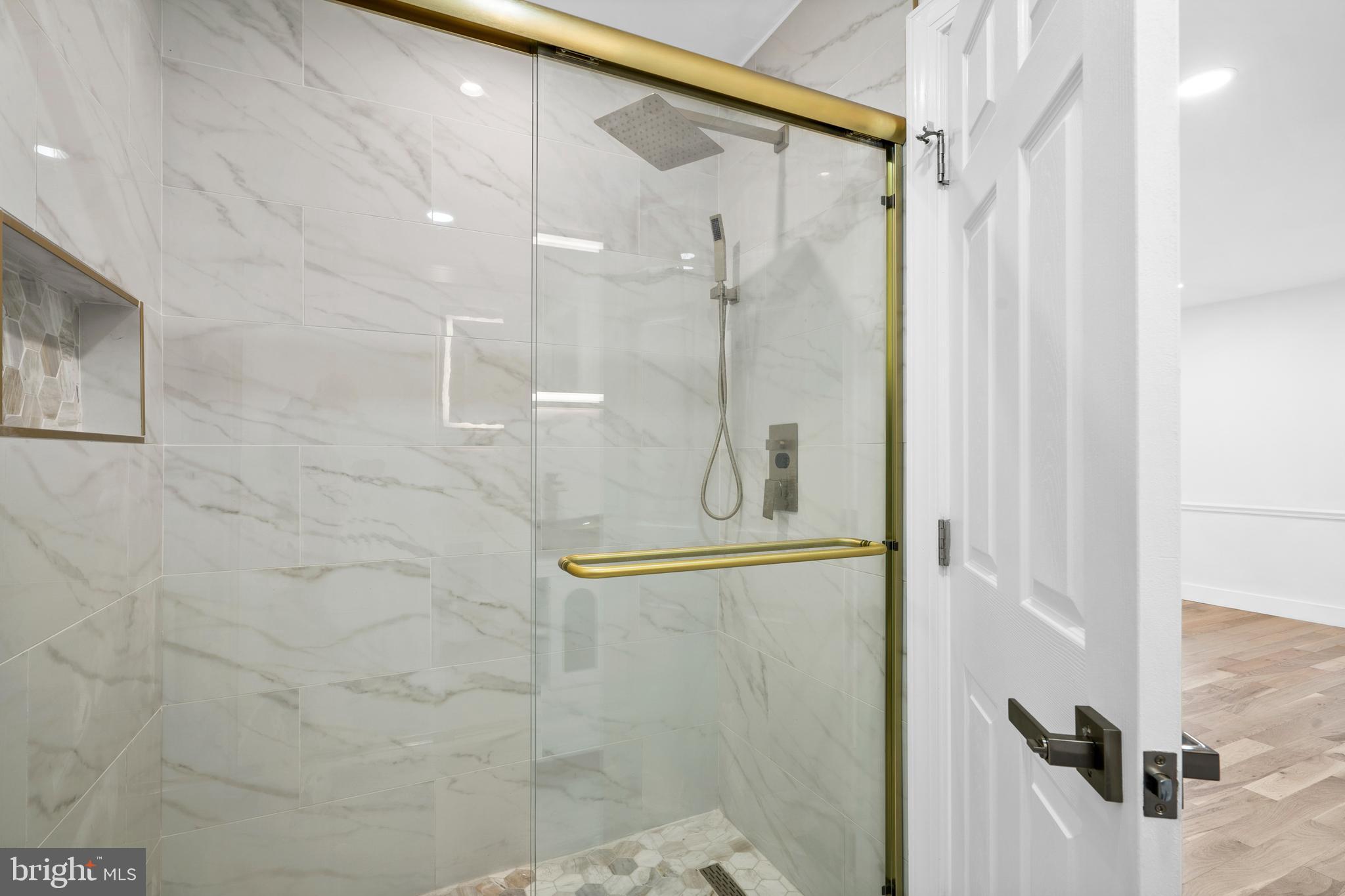 1007 Stoneham Drive, Unit 1007B Newtown Square, PA 19073 - Photo 14 of 31 a bathroom with a glass shower door