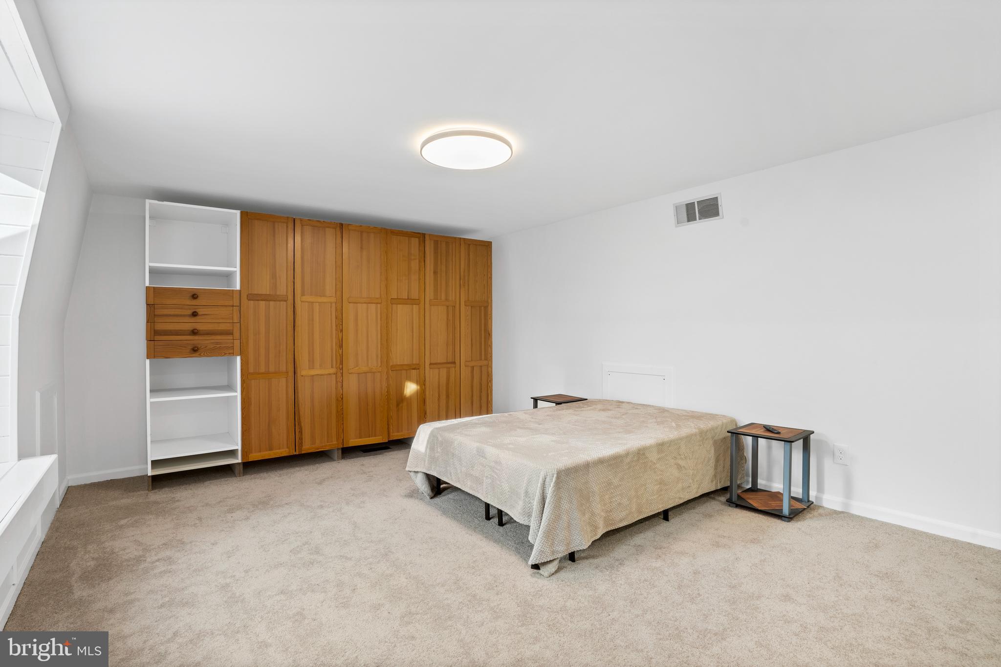1007 Stoneham Drive, Unit 1007B Newtown Square, PA 19073 - Photo 21 of 31 a spacious bedroom with a bed and cabinet