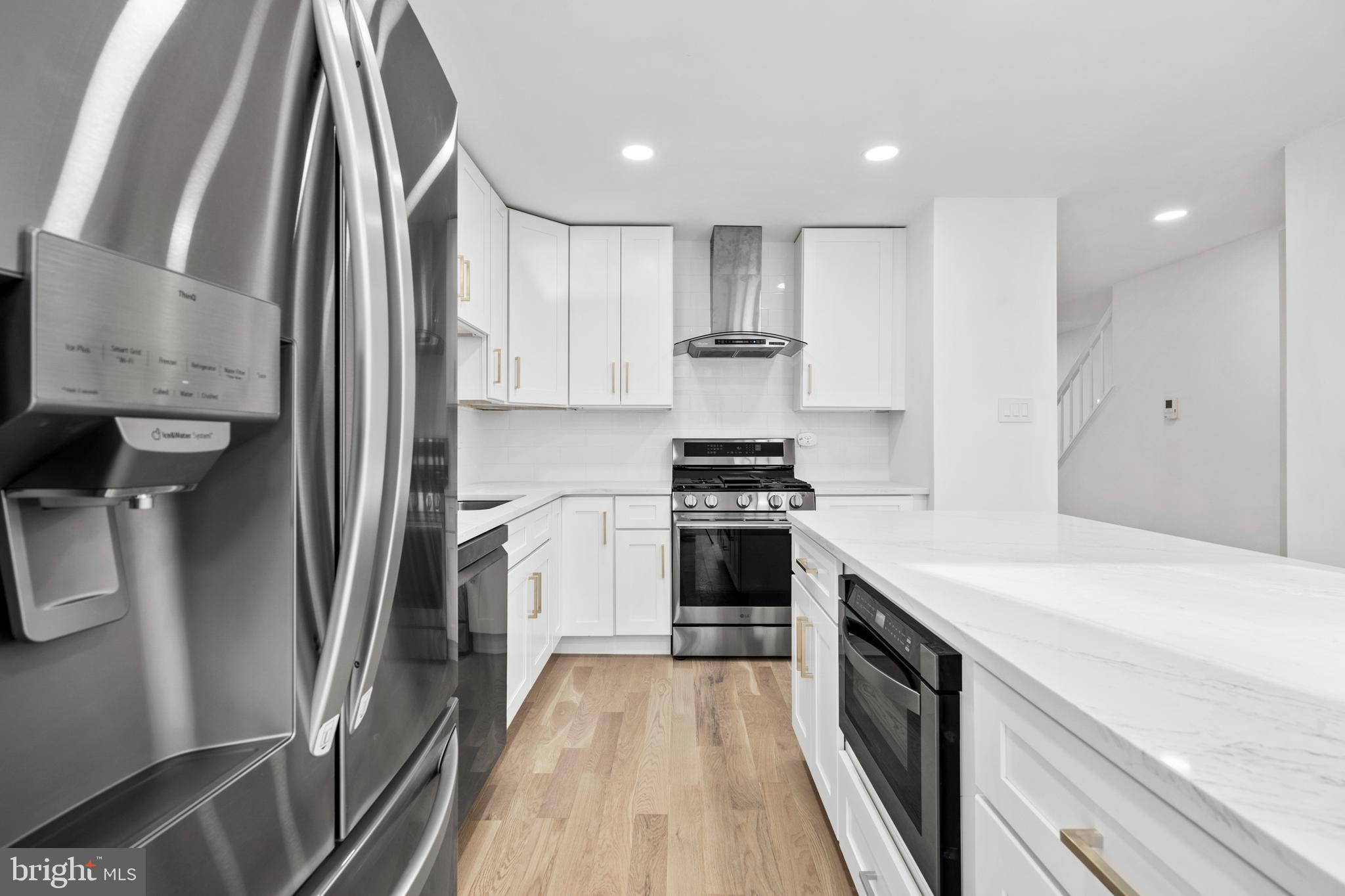 1007 Stoneham Drive, Unit 1007B Newtown Square, PA 19073 - Photo 3 of 31 a kitchen with stainless steel appliances sink stove refrigerator and cabinets