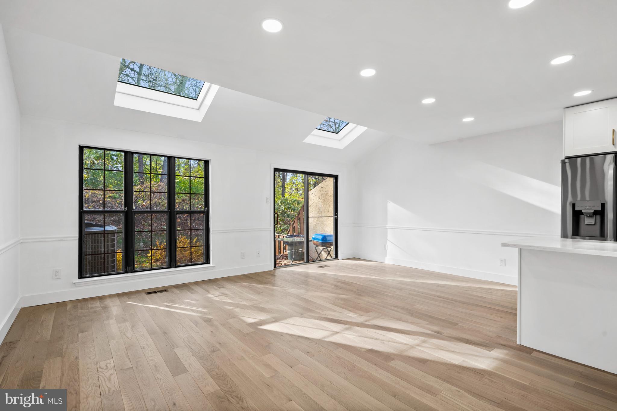 1007 Stoneham Drive, Unit 1007B Newtown Square, PA 19073 - Photo 6 of 31 a view of an empty room with a window and wooden floor