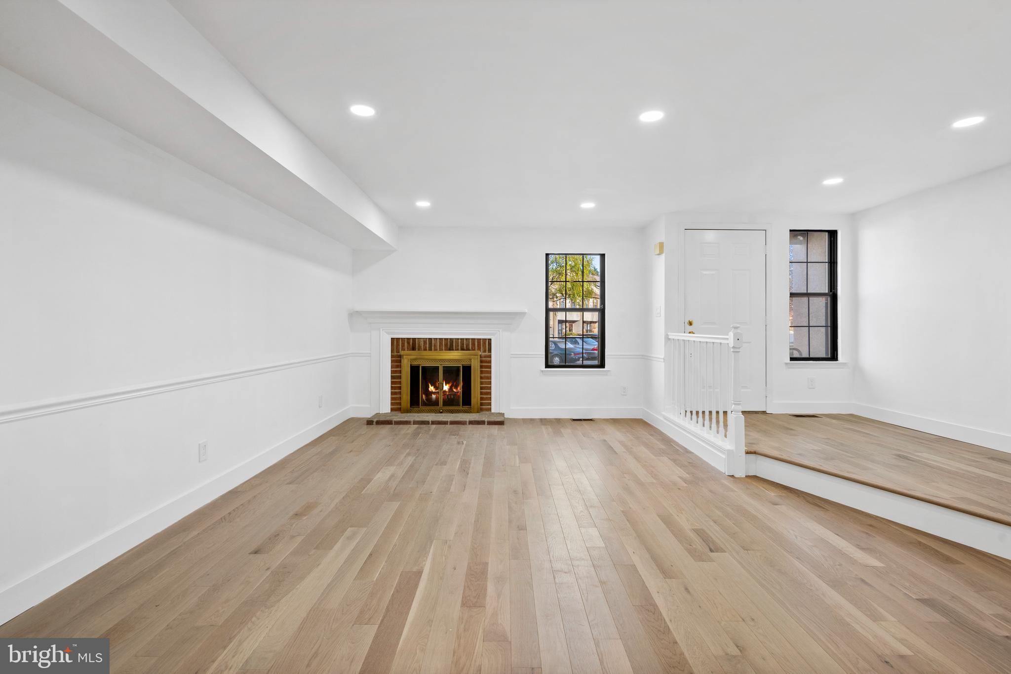 1007 Stoneham Drive, Unit 1007B Newtown Square, PA 19073 - Photo 8 of 31 an empty room with windows and fireplace
