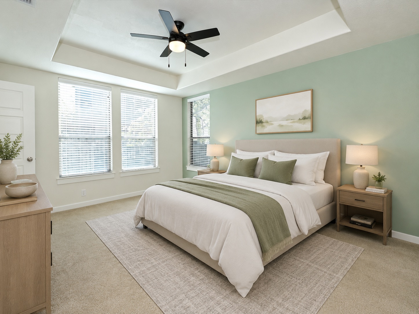 2101 Rivers Edge Way, Unit 29 Austin, TX 78741 - Photo 15 of 38 Virtually Staged. Main floor primary bedroom featuring a tray ceiling with a ceiling fan, multiple windows with blinds, and carpeted flooring
