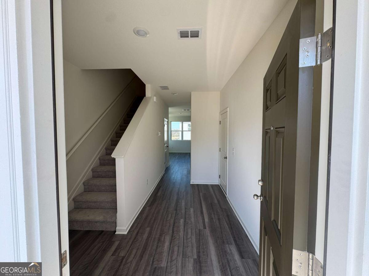 423 Towson Street, Unit 233 Villa Rica, GA 30180 - Photo 2 of 18 a view of a hallway with wooden floor and staircase
