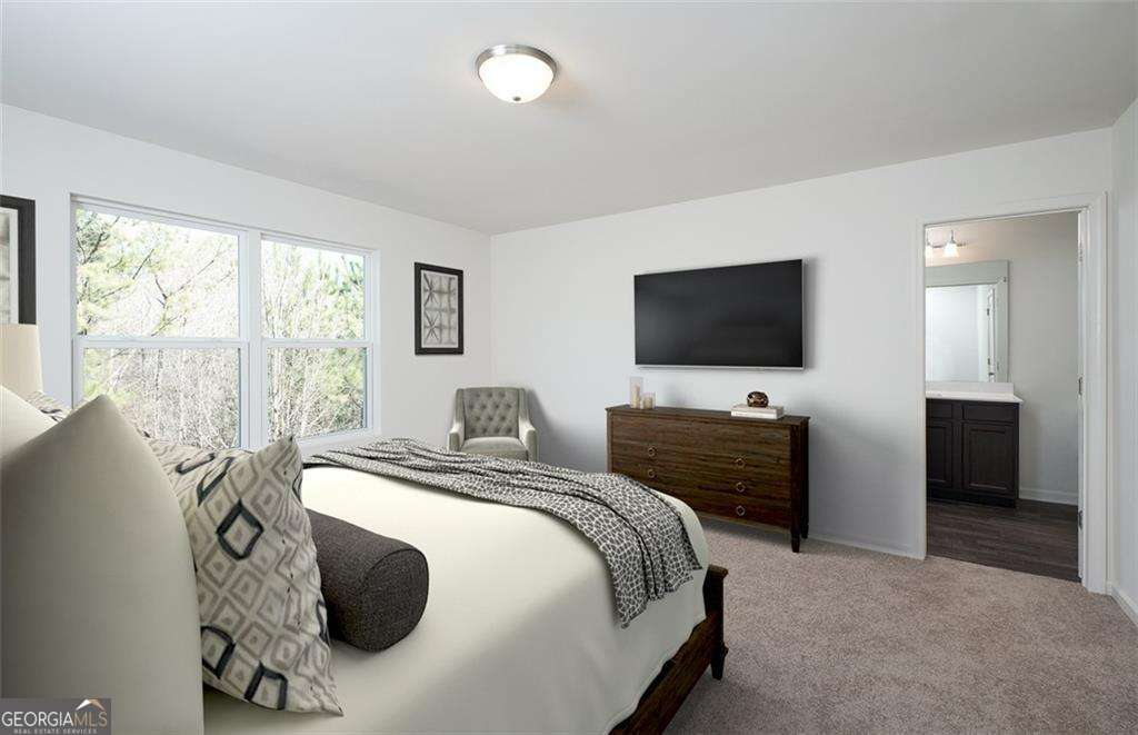 423 Towson Street, Unit 233 Villa Rica, GA 30180 - Photo 5 of 18 a bedroom with a bed and a flat screen tv