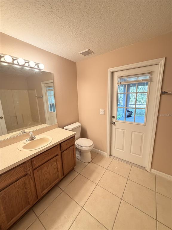 4 Wheeldon Lane Palm Coast, FL 32164 - Photo 13 of 21 a spacious bathroom with a granite countertop sink a toilet and mirror