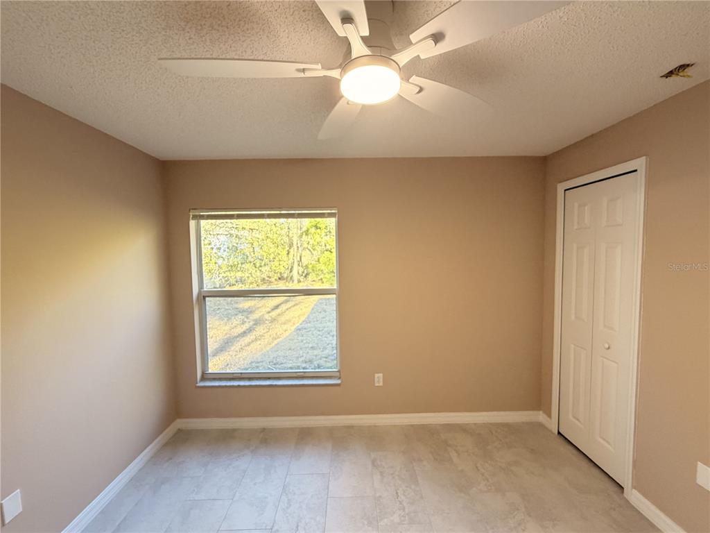 4 Wheeldon Lane Palm Coast, FL 32164 - Photo 16 of 21 an empty room with windows and fan