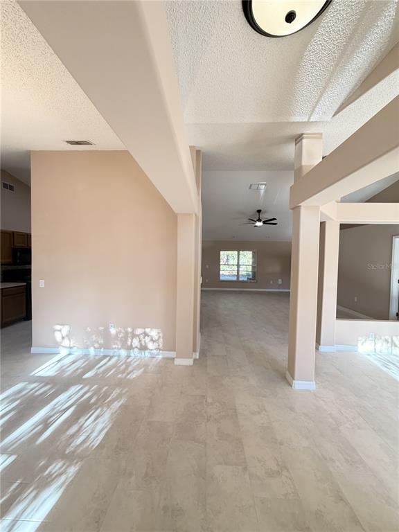 4 Wheeldon Lane Palm Coast, FL 32164 - Photo 2 of 21 a view of a hallway with wooden floor and a living room