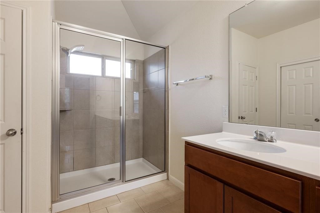 5428 Falling Leaf Lane, Unit 87 Austin, TX 78744 - Photo 19 of 31 a bathroom with a shower sink and mirror