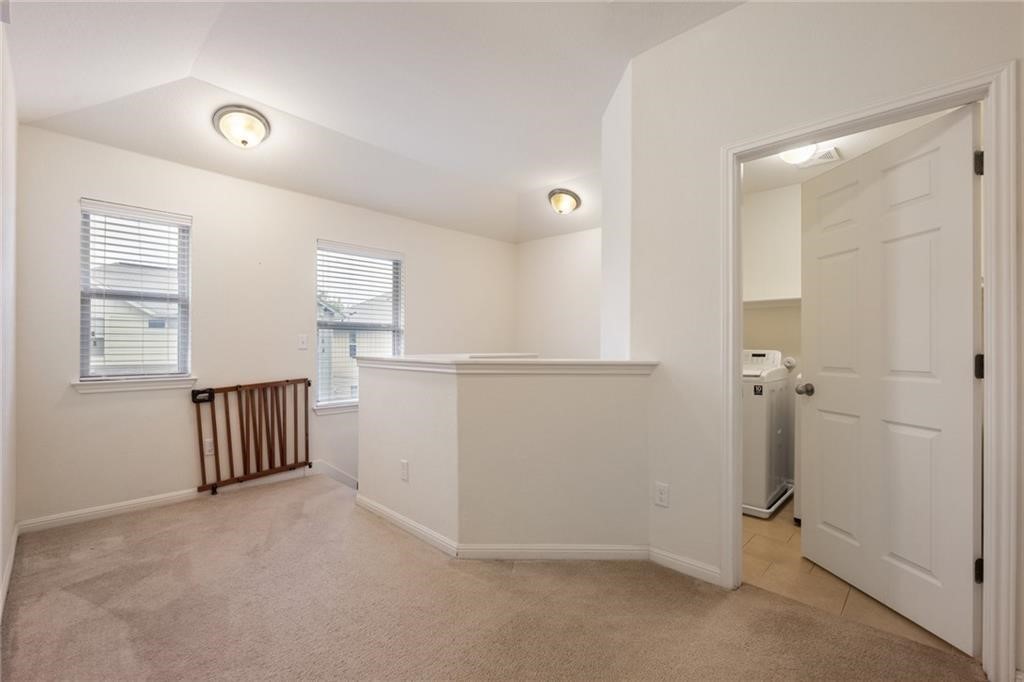 5428 Falling Leaf Lane, Unit 87 Austin, TX 78744 - Photo 25 of 31 wooden floor and cabinet in a room
