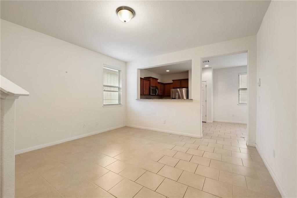 5428 Falling Leaf Lane, Unit 87 Austin, TX 78744 - Photo 5 of 31 an empty room with white walls and windows