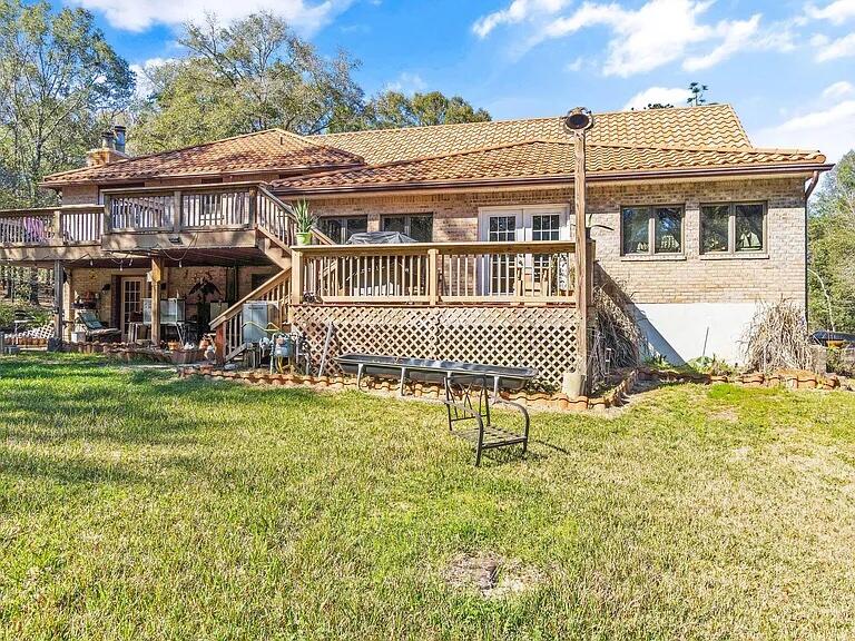 3194 Bay Ridge Drive Crestview, FL 32539 - Photo 78 of 88 a front view of a house with a yard table and chairs