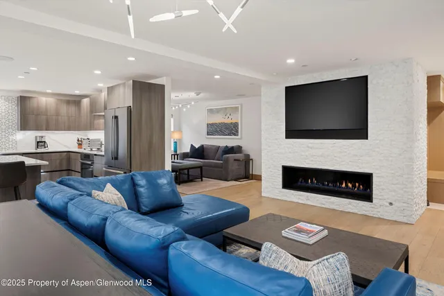 a living room with furniture and a flat screen tv
