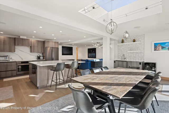 a large kitchen with a table and chairs