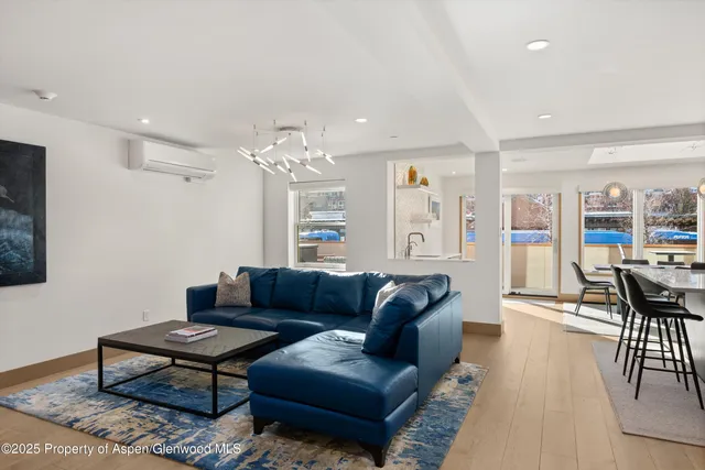 a living room with furniture a table and chairs