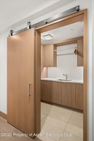 a utility room with sink dryer and washer