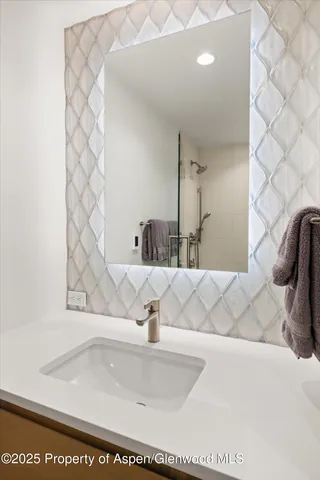 a bathroom with a granite countertop sink a toilet and a mirror