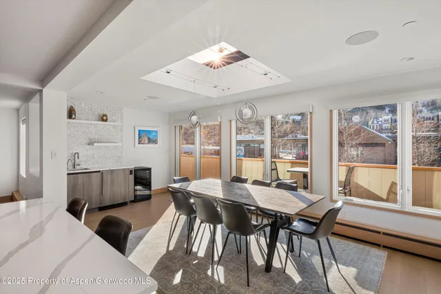 a view of a dining room with furniture window and wooden floor