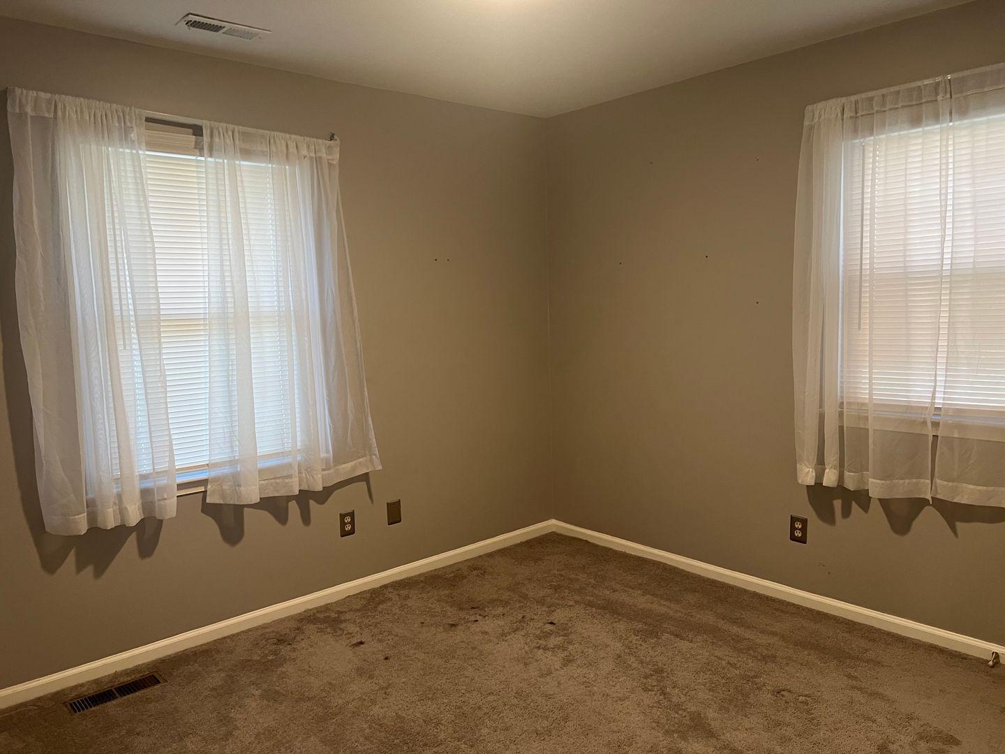 5912 Pine Tree Court Raleigh, NC 27609 - Photo 17 of 18 an empty room with a window