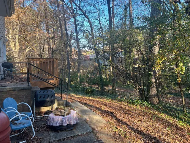 a wooden bench sitting in front of a house
