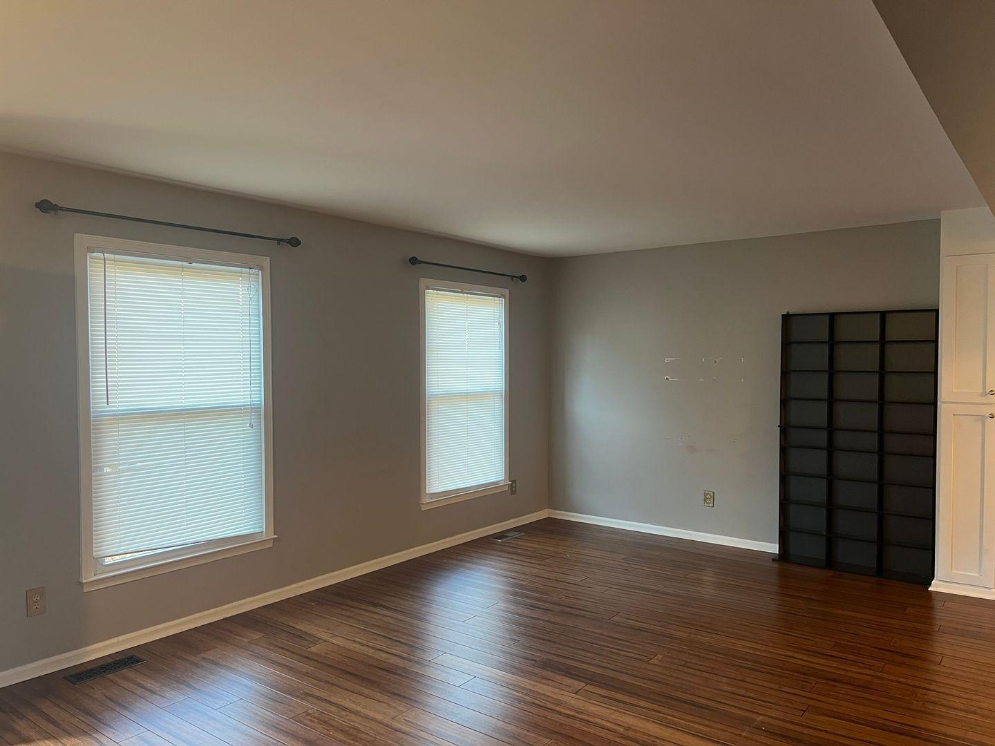 5912 Pine Tree Court Raleigh, NC 27609 - Photo 3 of 18 an empty room with wooden floor and windows