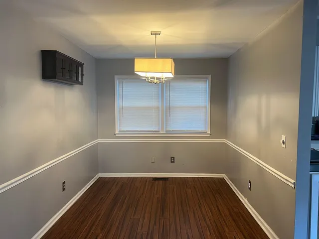 a room with a wooden floor and a window