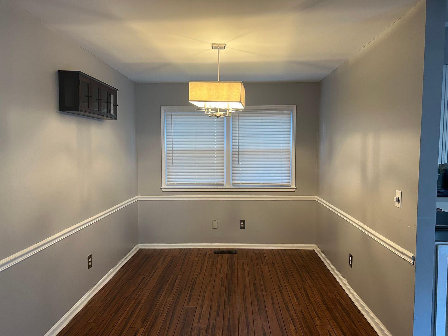 5912 Pine Tree Court Raleigh, NC 27609 - Photo 4 of 18 a room with a wooden floor and a window