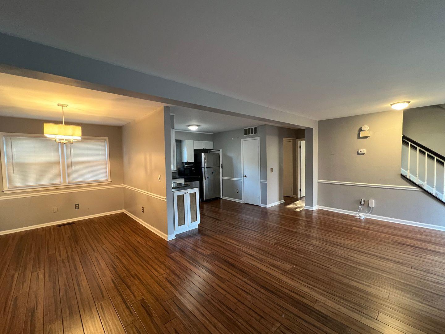 5912 Pine Tree Court Raleigh, NC 27609 - Photo 6 of 18 a view of empty room with wooden floor and window