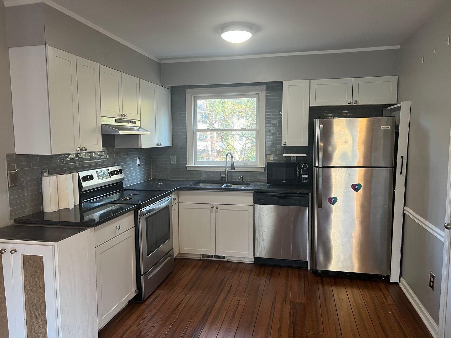 5912 Pine Tree Court Raleigh, NC 27609 - Photo 7 of 18 a kitchen with stainless steel appliances a refrigerator sink and microwave