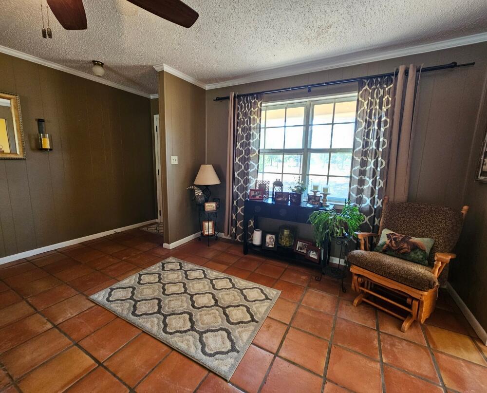 4017 Bear Creek Road Crestview, FL 32539 - Photo 9 of 30 a living room with furniture and a floor to ceiling window