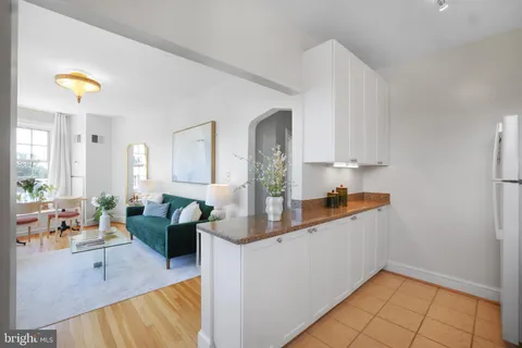 a living room with fireplace furniture and a table