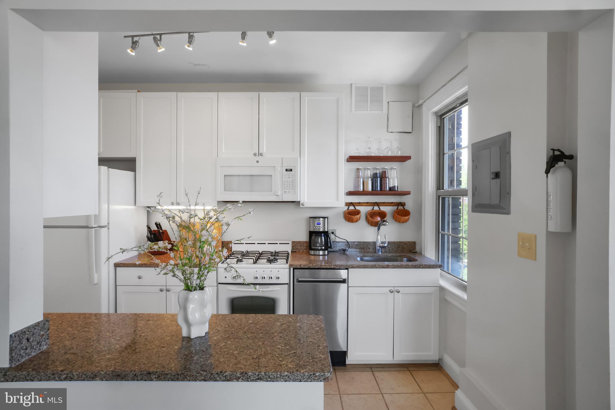3446 Connecticut Avenue Northwest, Unit 502 Washington, DC 20008 - Photo 13 of 35 a kitchen with white cabinets and appliances