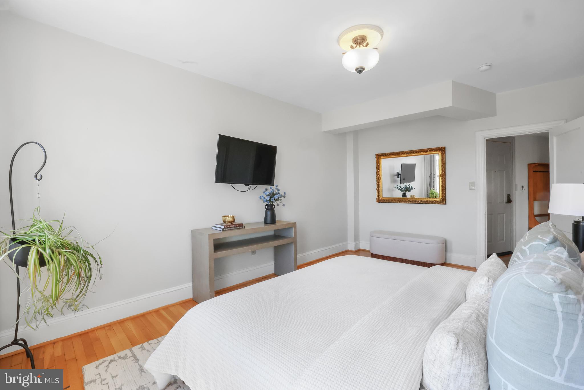 3446 Connecticut Avenue Northwest, Unit 502 Washington, DC 20008 - Photo 21 of 35 a bedroom with a bed and a flat screen tv