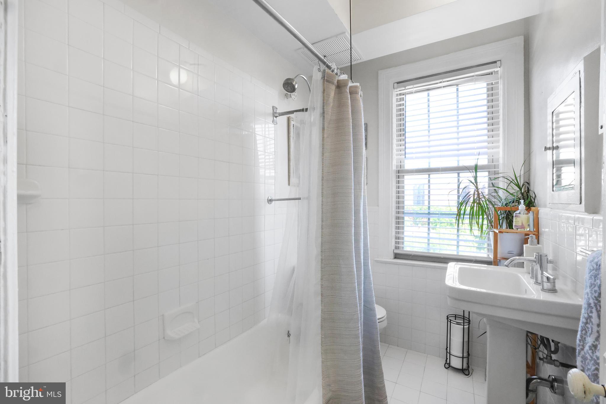3446 Connecticut Avenue Northwest, Unit 502 Washington, DC 20008 - Photo 23 of 35 a bathroom with a sink a toilet and shower