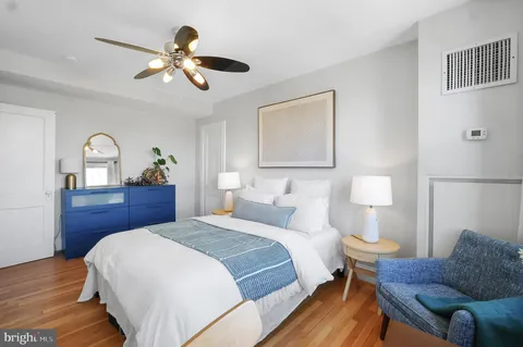 a bedroom with a large bed and a couch