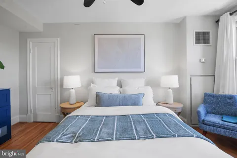 a bed sitting in a bedroom next to a window