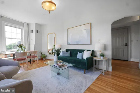 a living room with furniture a rug and a large window