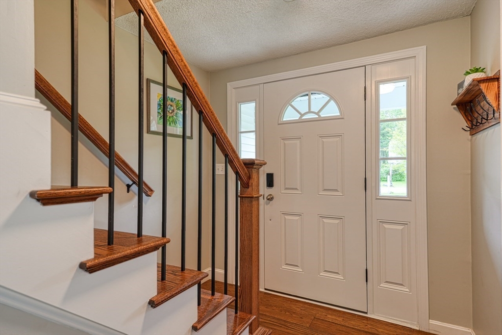 3 Alcorn Road Chelmsford, MA 01824 - Photo 13 of 39 a view of entryway with wooden floor and stairs