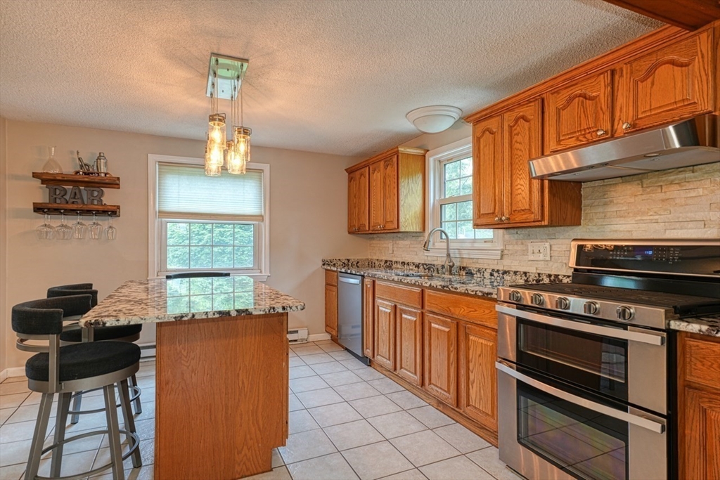 3 Alcorn Road Chelmsford, MA 01824 - Photo 2 of 39 a kitchen with stainless steel appliances granite countertop a stove sink and cabinets