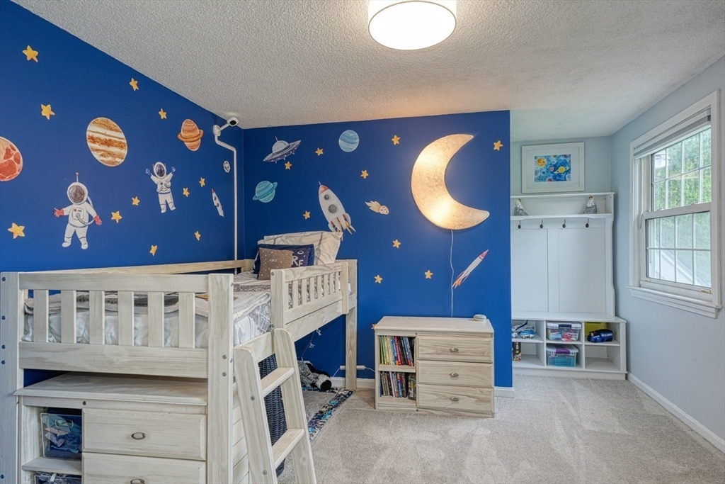 3 Alcorn Road Chelmsford, MA 01824 - Photo 21 of 39 a bedroom with a bed and a chandelier