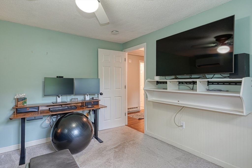 3 Alcorn Road Chelmsford, MA 01824 - Photo 25 of 39 a room with a chair and a flat screen tv