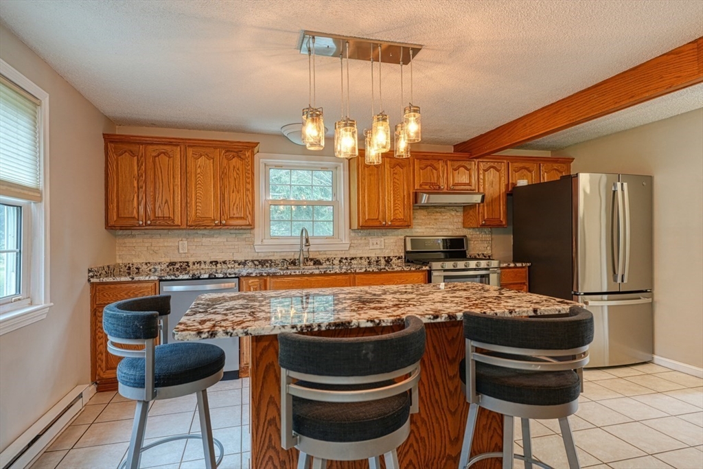 3 Alcorn Road Chelmsford, MA 01824 - Photo 3 of 39 a kitchen with granite countertop a sink stove and refrigerator
